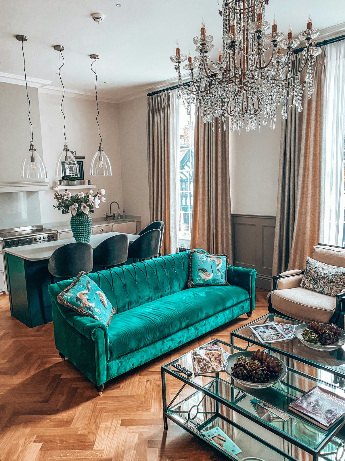 Elegant living room with teal sofa and warm wood accents in Salt Lake residence